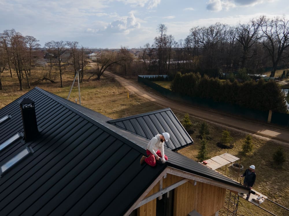 Two roofers working on an installation.